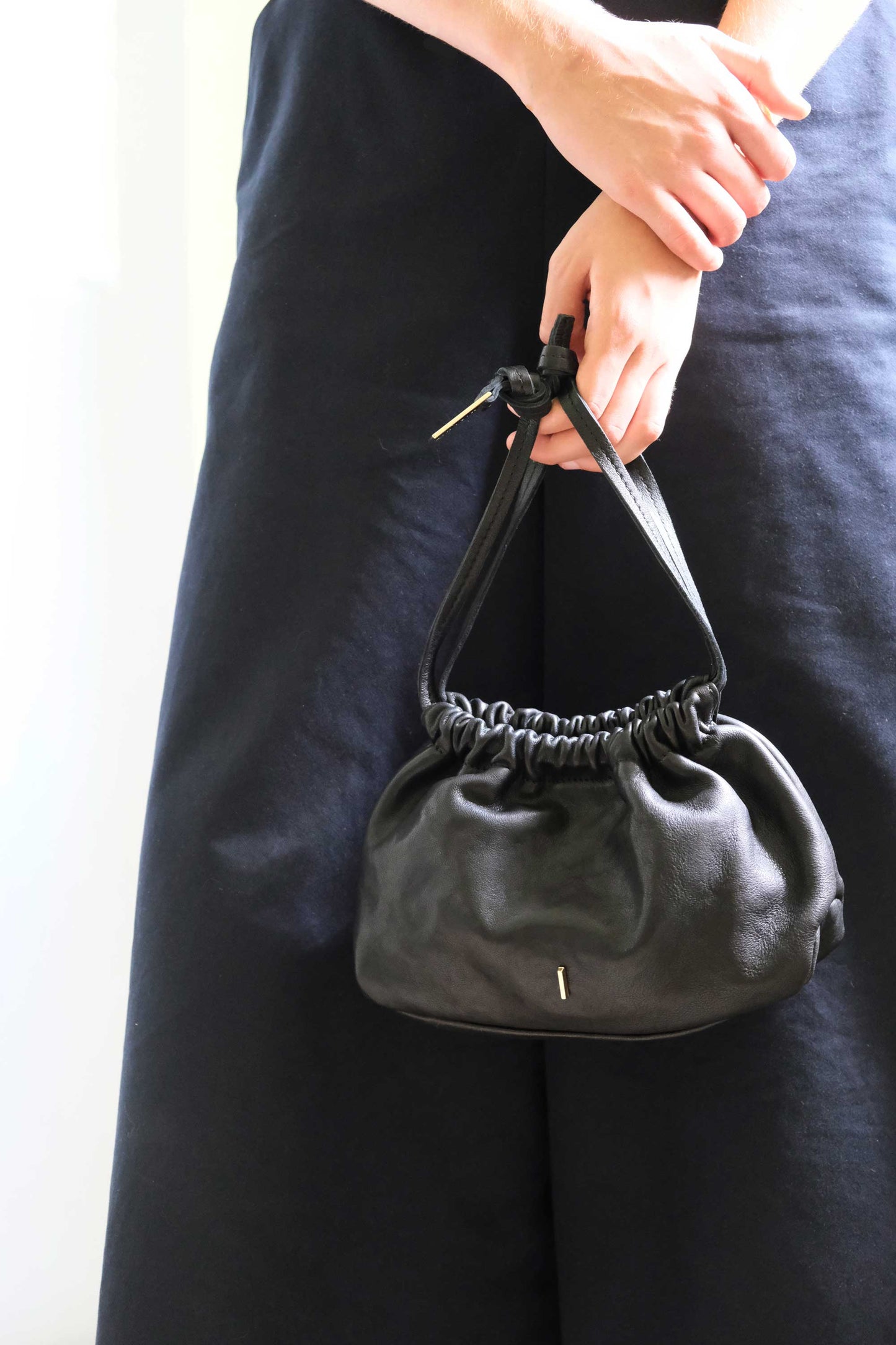 Agnes mini pochette in black nappa vegetable leather