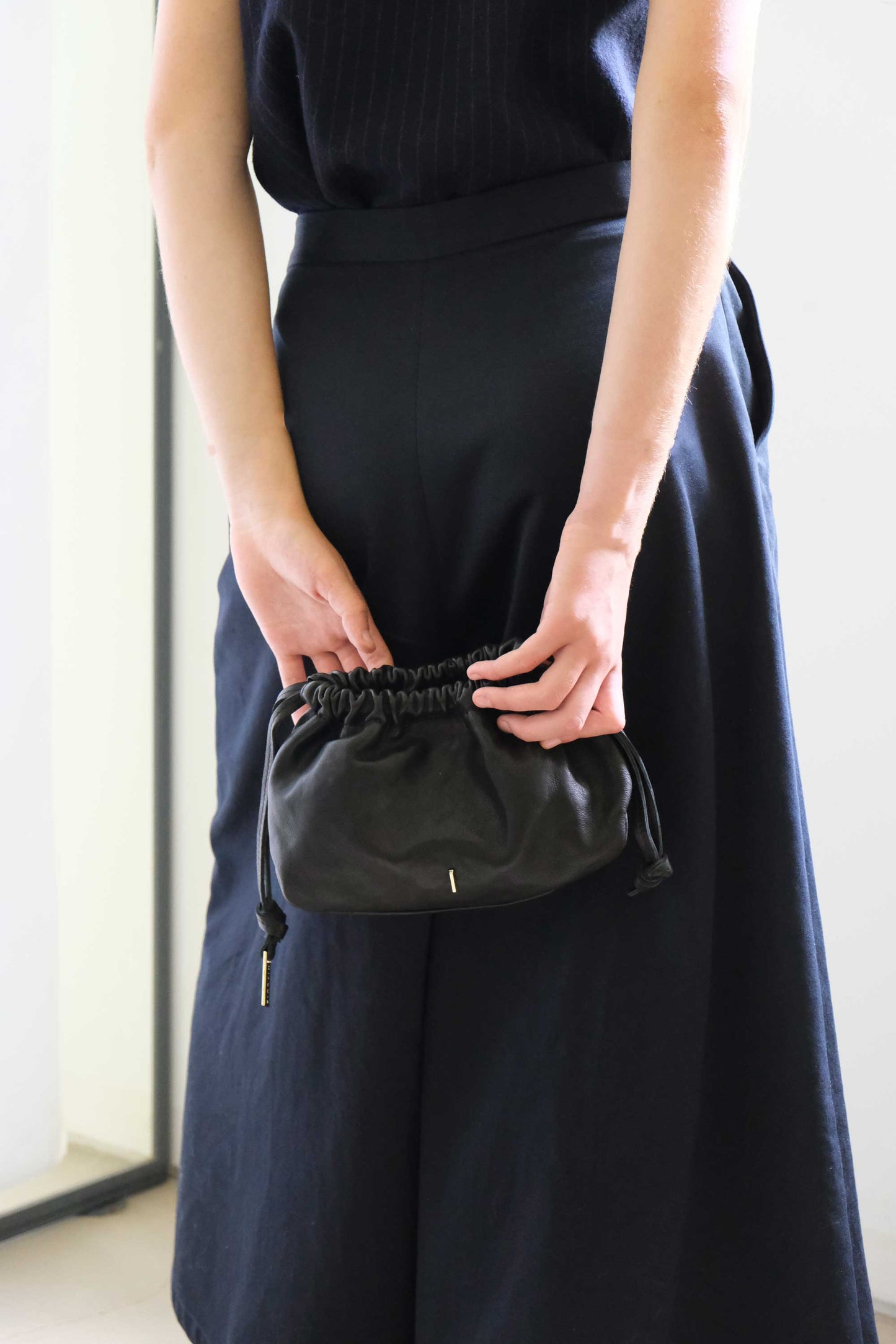 Agnes mini pochette in black nappa vegetable leather